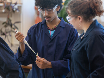 boy and girl in blue lab costs doing an experiment