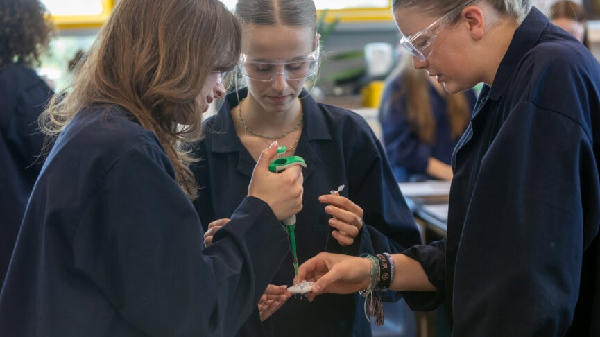 Female students in blue lab coats