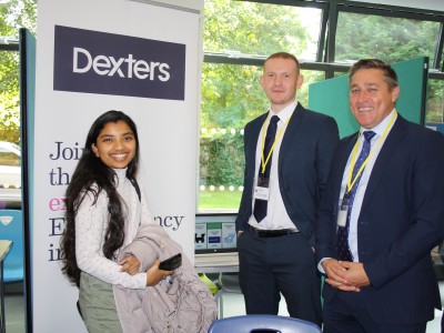 student talks to estate agent Dexters at an exhibition stand
