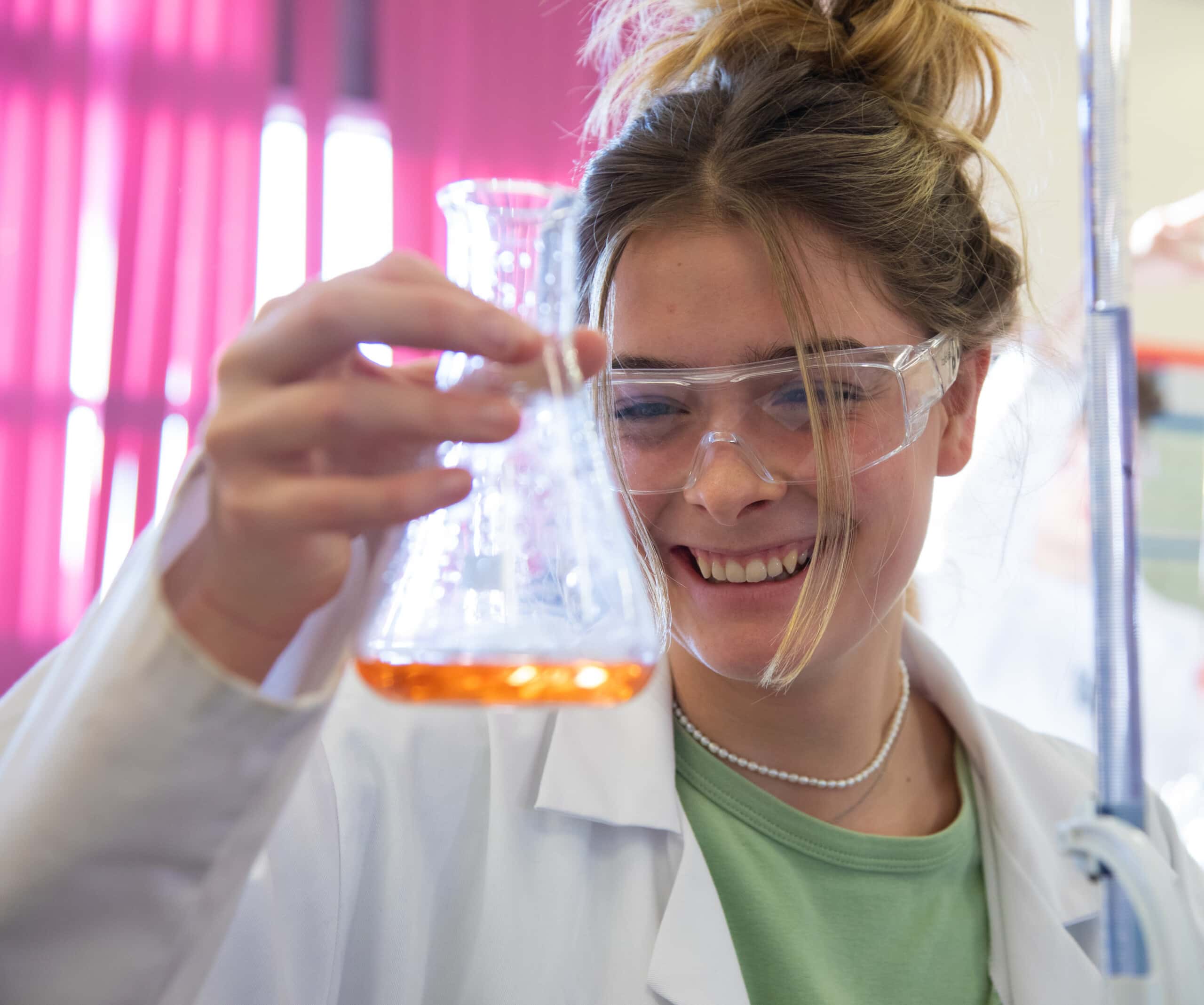 student holding test tube in lab