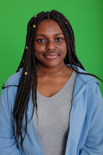 Girl Standing Against Green Background