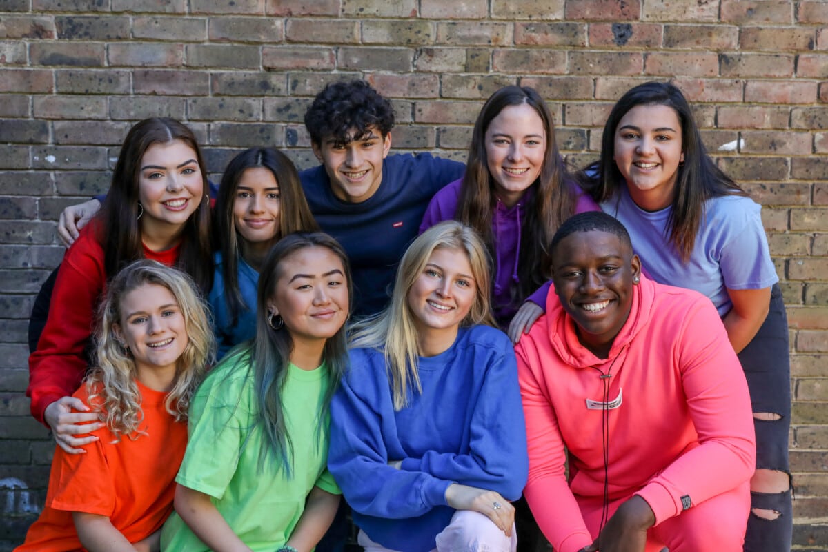 Group Of Students Sitting On A Bench