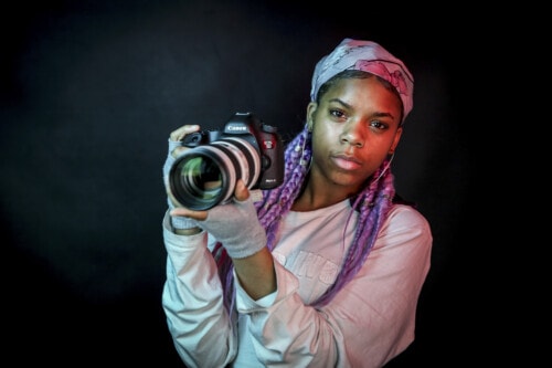 Girl holding camera in photography studio
