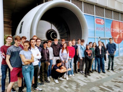 Physics Extracurricular Trip To Museum With Students Standing Outside
