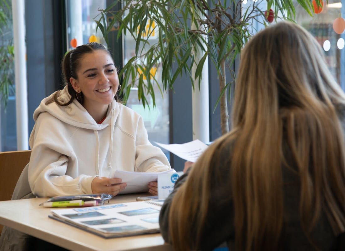 Girl sitting at table in library