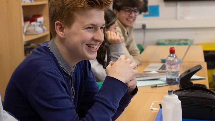 Boy smiling in Politics class