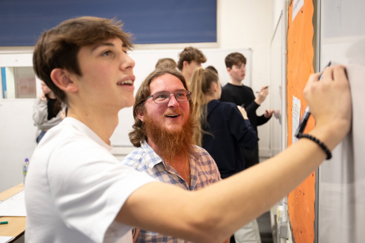 Malte student with a maths teacher working at the whiteboard