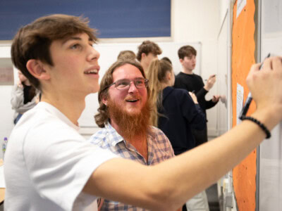 Malte student with a maths teacher working at the whiteboard