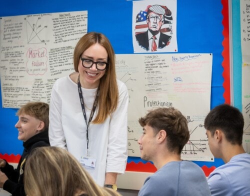 Melissa teaching in an economics classroom