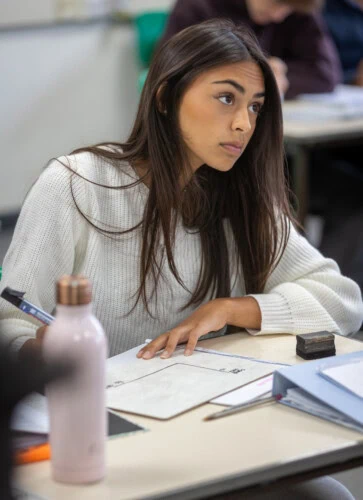 female student looking up from her desk