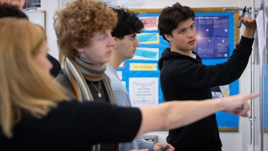 susan tuffy with math students at the whiteboard