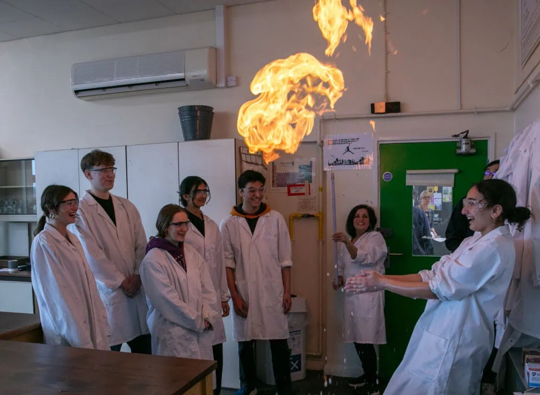 Students doing an experiment with fire in chemistry lab