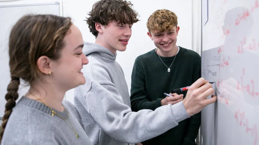 Maths students doing maths at the whiteboard