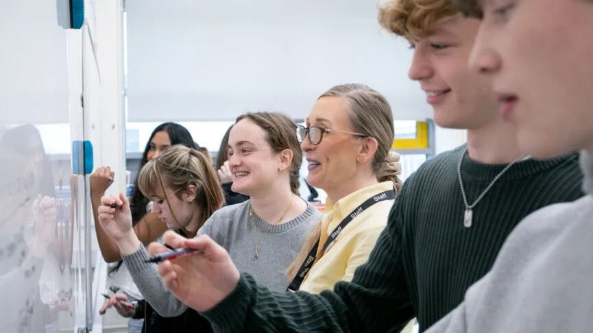 maths students with Sam at the whiteboard