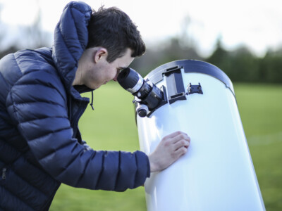 Physic Student Looks Through A Telescope
