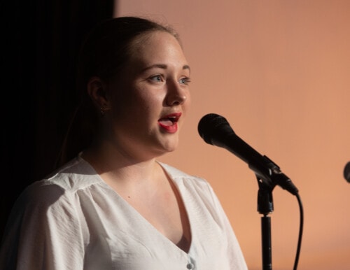 Female student speaking into microphone