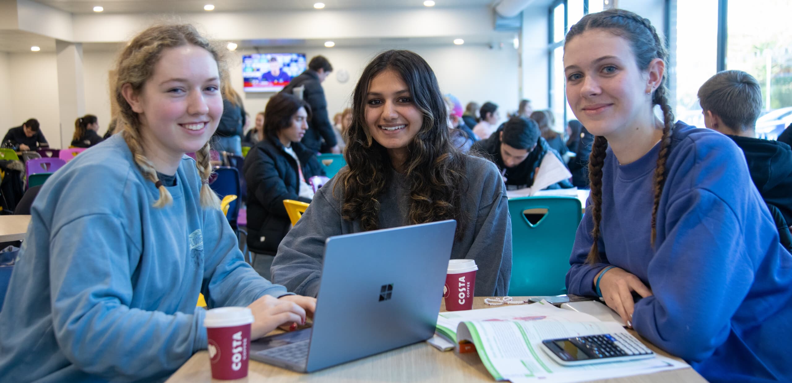 Girls in cafe on laptop