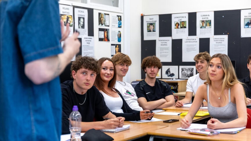 A mixed group of students in a media classroom