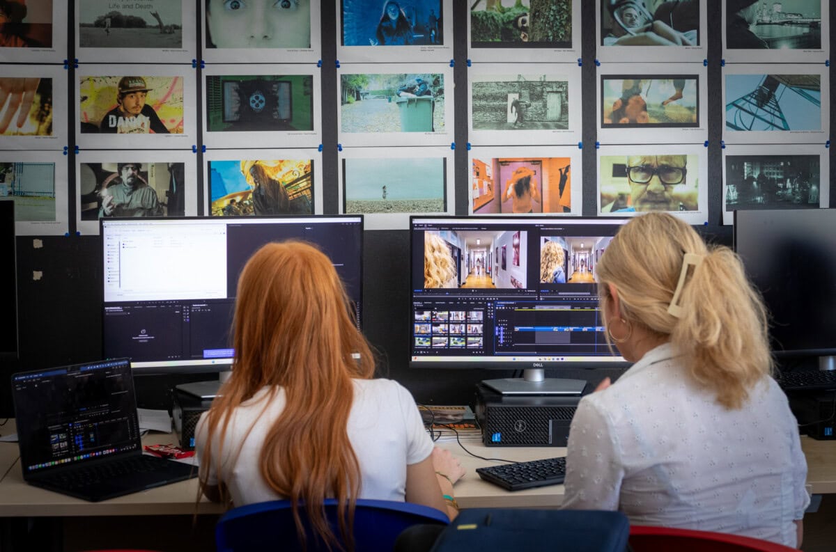 Two female students using editing software