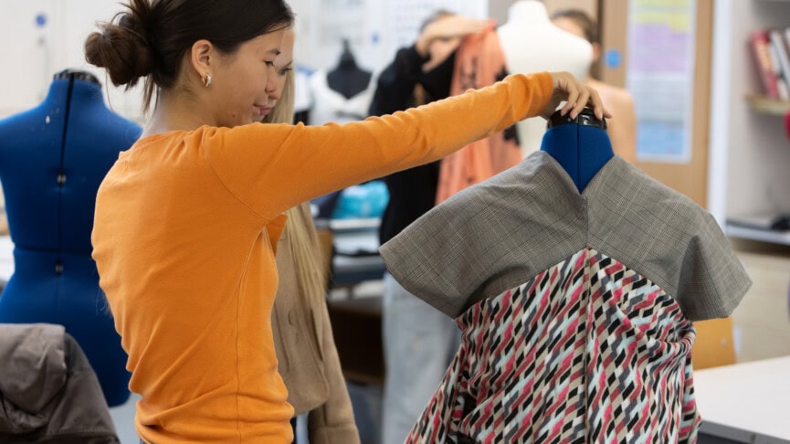 fashion student pinning a mannequin