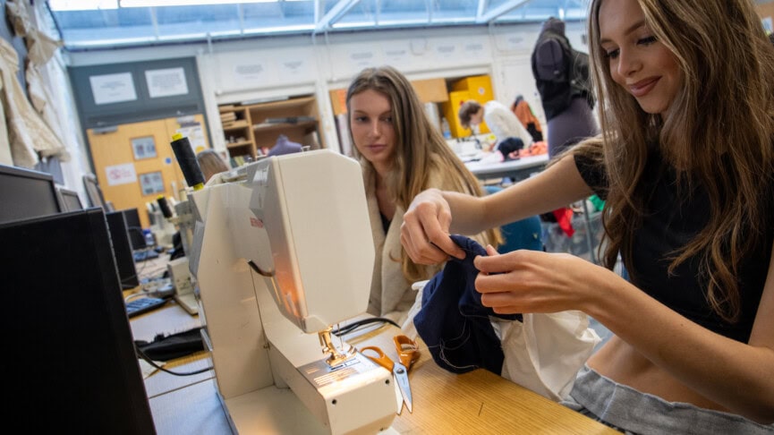 two fashion students using sewing machines