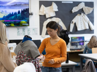 fashion student working at a mannequin