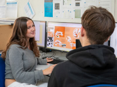 two 3d design students chatting in class
