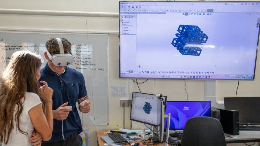 two students in 3d design using the VR headset in a classroom