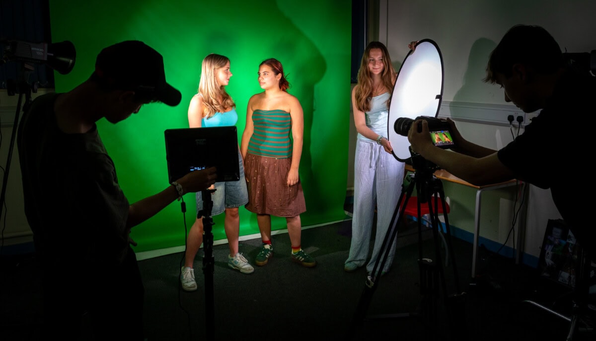 Students on a TV production set filming