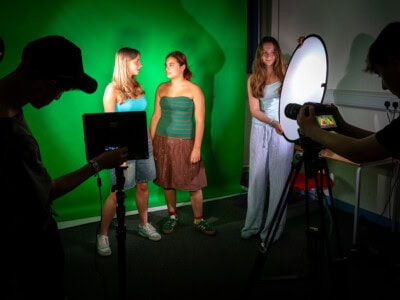 Students on a TV production set filming