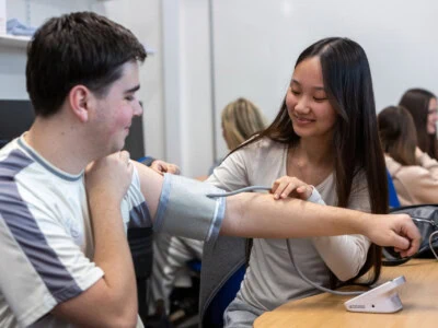 health and social care students performing a blood pressure check