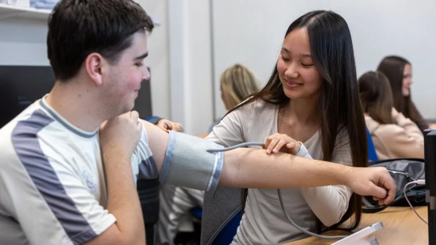 health and social care students performing a blood pressure check