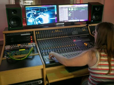 Student using the mixing decs in the music studio