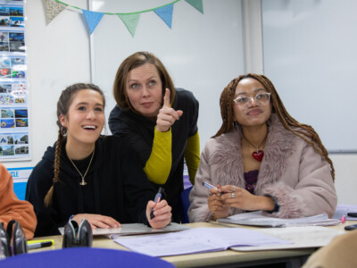 Business teacher with students pointing