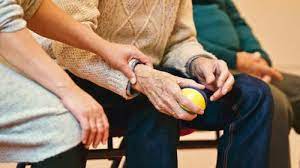 A young person caring for an elderly man