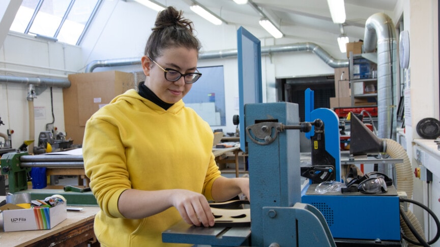 Eda at sanding machine in workshop