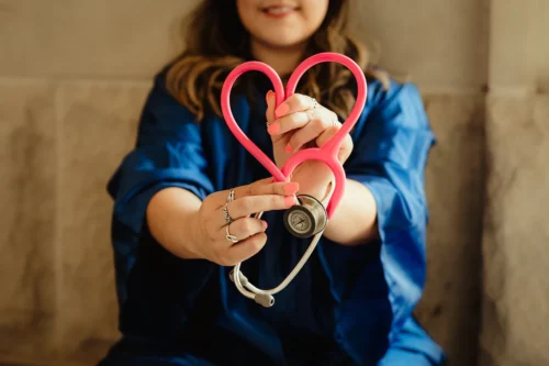 Woman holding heart stethoscope