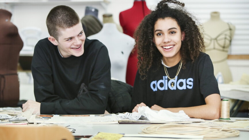 Fashion and textiles students sitting at desk