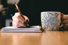 Woman writing with coffee