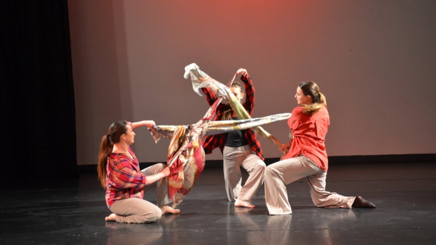 dance A level students performing with coloured materials