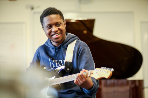 Male Student Playing Guitar