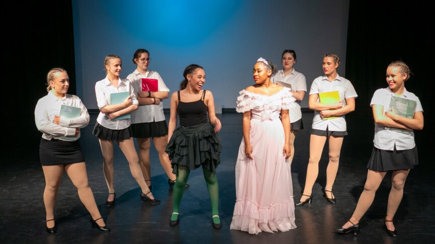 Wicked Ensemble laughing on stage