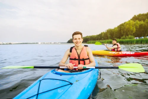 Young man on kayaking on a lake