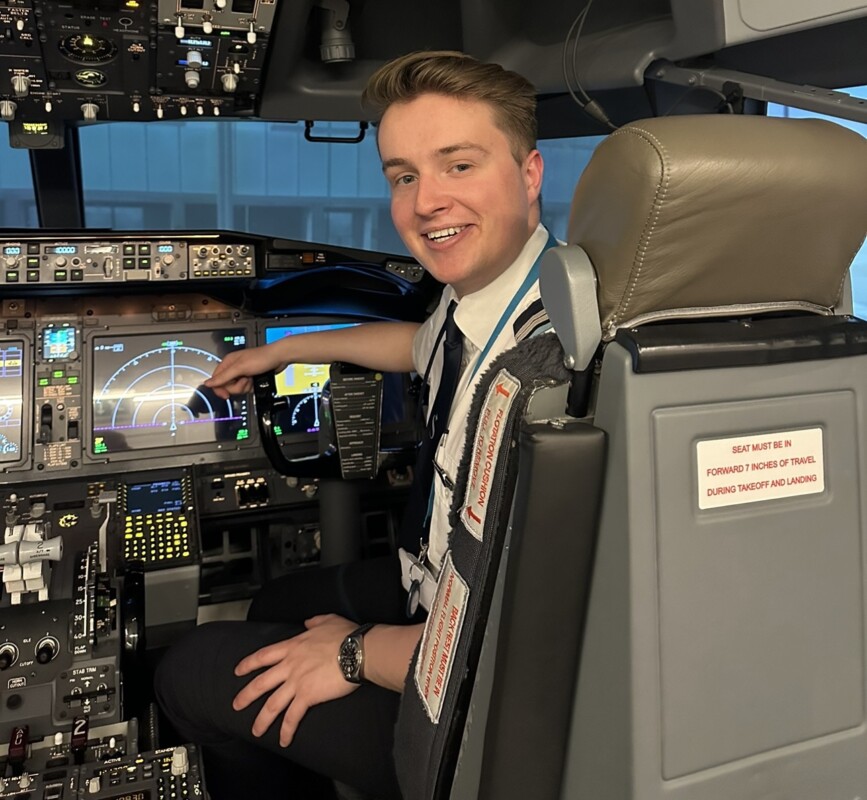Alumni Josh Black Pilot sitting in a cockpit
