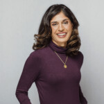 Alumni and Engineer Dipalee Jukes standing with her hands on hips smiling at the camera