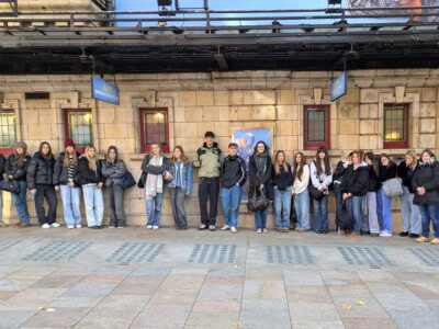 Group shot of students standing outside a theatre in London