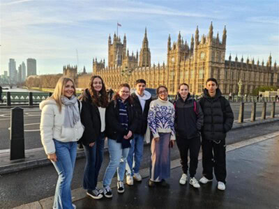 A group of students with the palace of Westminster behind them