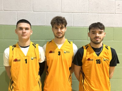 Three basketball players wearing their Esher kit