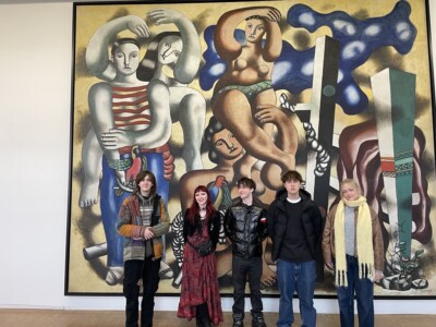 5 students standing in front of a mural in Paris