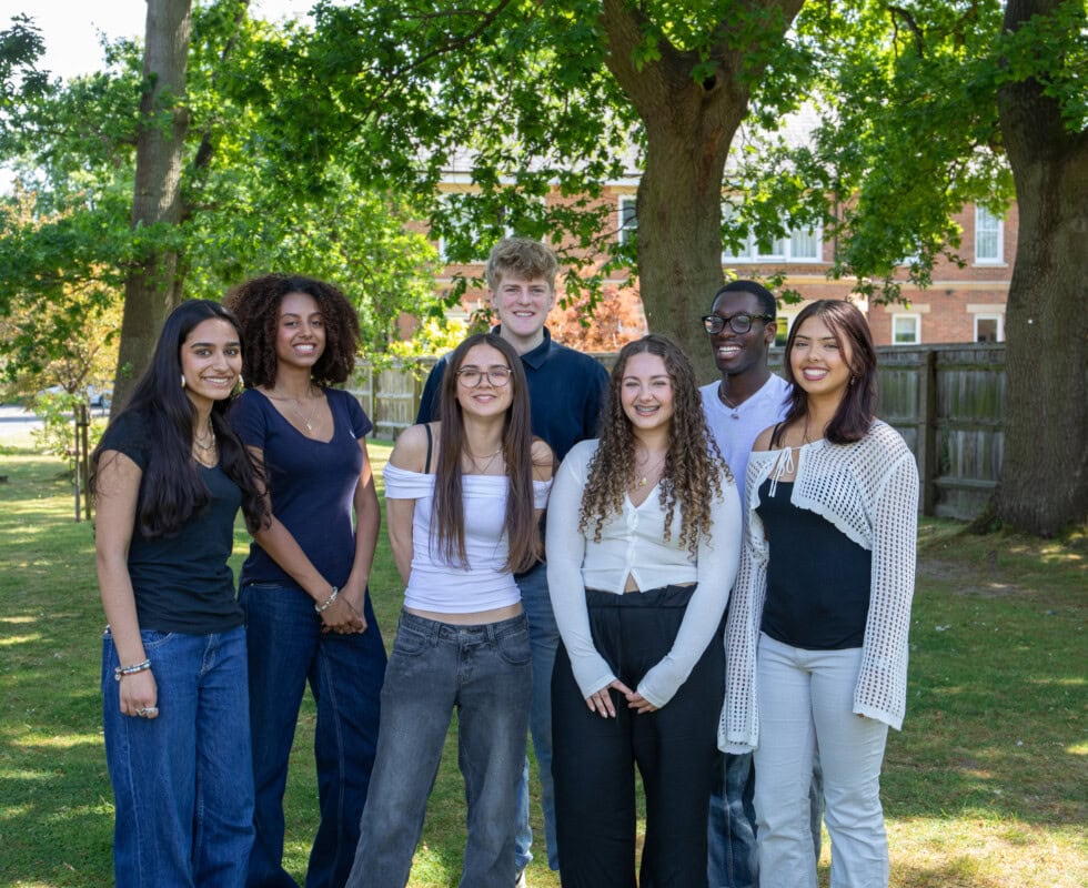 Student union group of 6 group of standing under the trees smiling